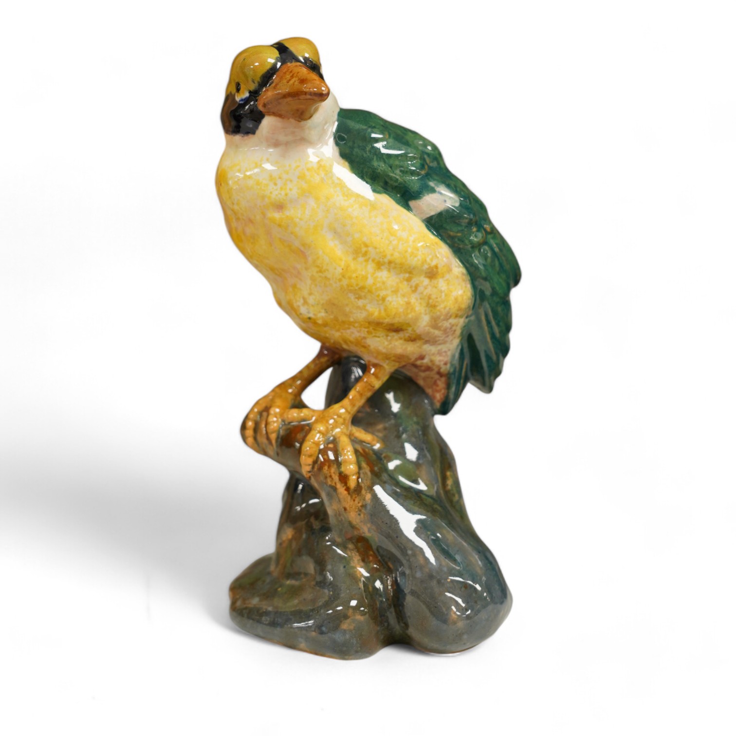 In the manner of Karlsruhe, an Austrian or Italian faience hand painted perching bird, impressed 1532 DO16 etc., 21cm high. Condition - fair to good, minor chips to base